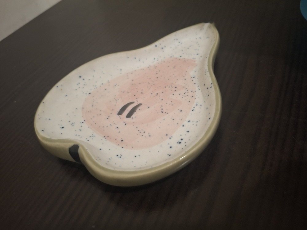 Pear-shaped speckled ceramic dish with a pink centre